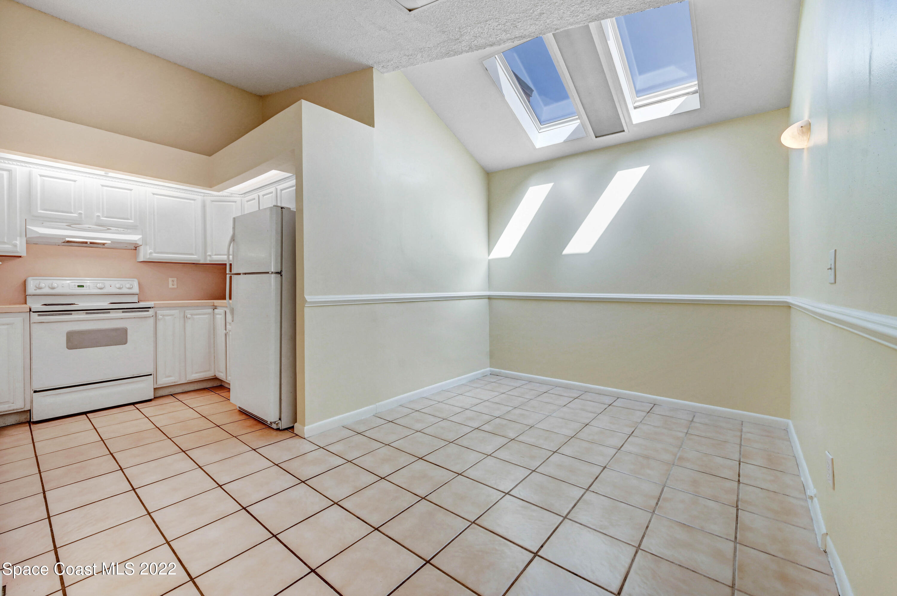 373 Myrtlewood Road Melbourne, FL 32940 - Photo 14 of 42 a view of a kitchen with white cabinets