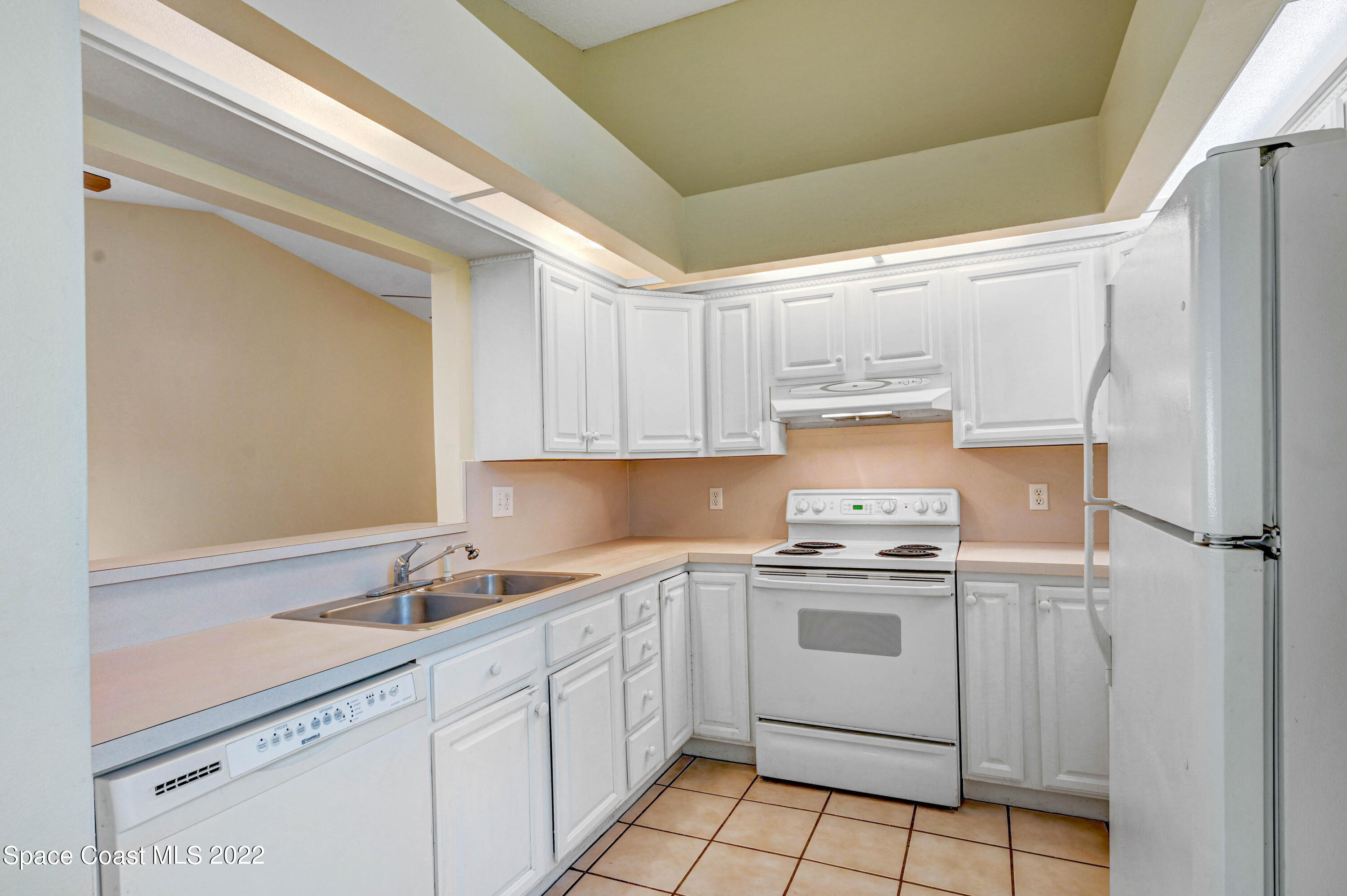 373 Myrtlewood Road Melbourne, FL 32940 - Photo 15 of 42 a kitchen with a sink stove and cabinets