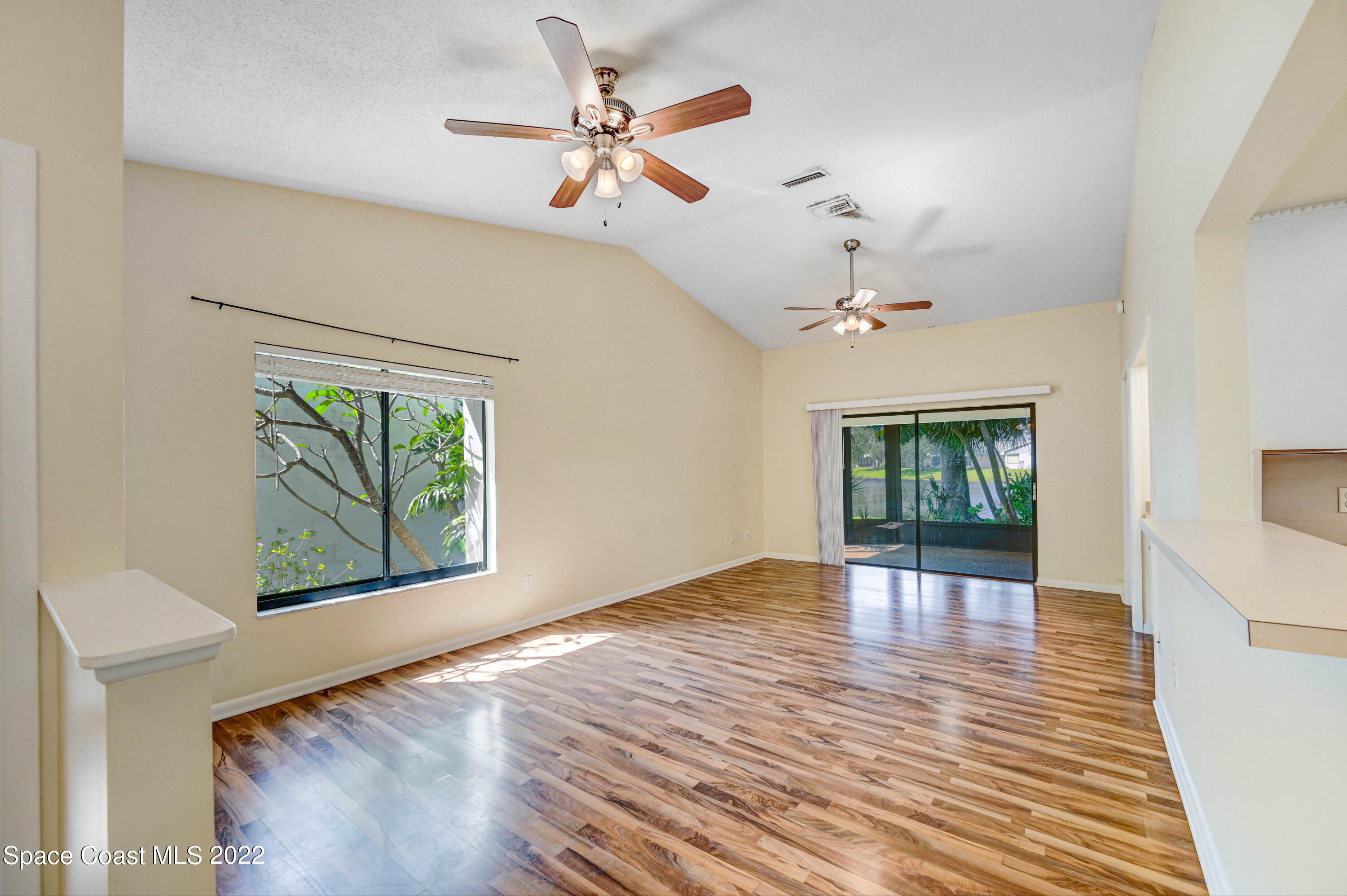 373 Myrtlewood Road Melbourne, FL 32940 - Photo 19 of 42 wooden floor in an empty room with a window