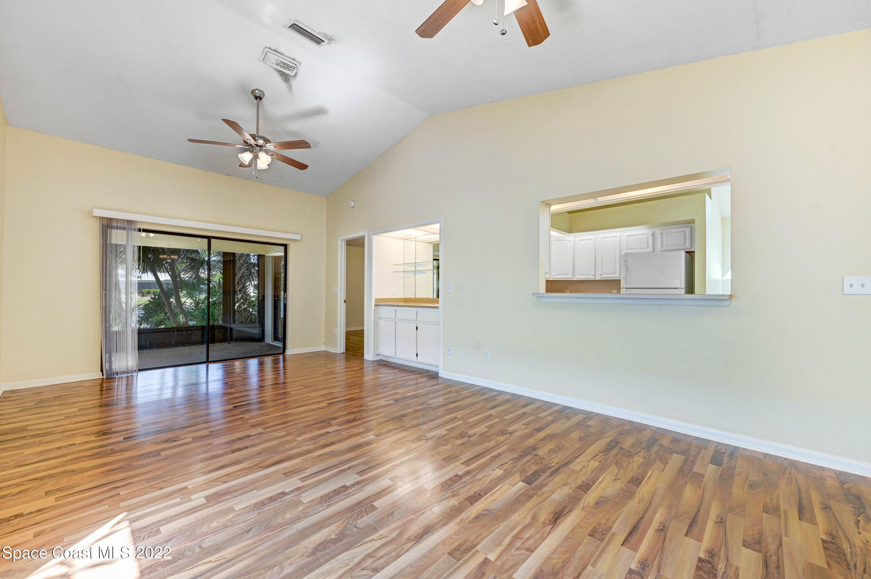 373 Myrtlewood Road Melbourne, FL 32940 - Photo 20 of 42 wooden floor in an empty room with a window