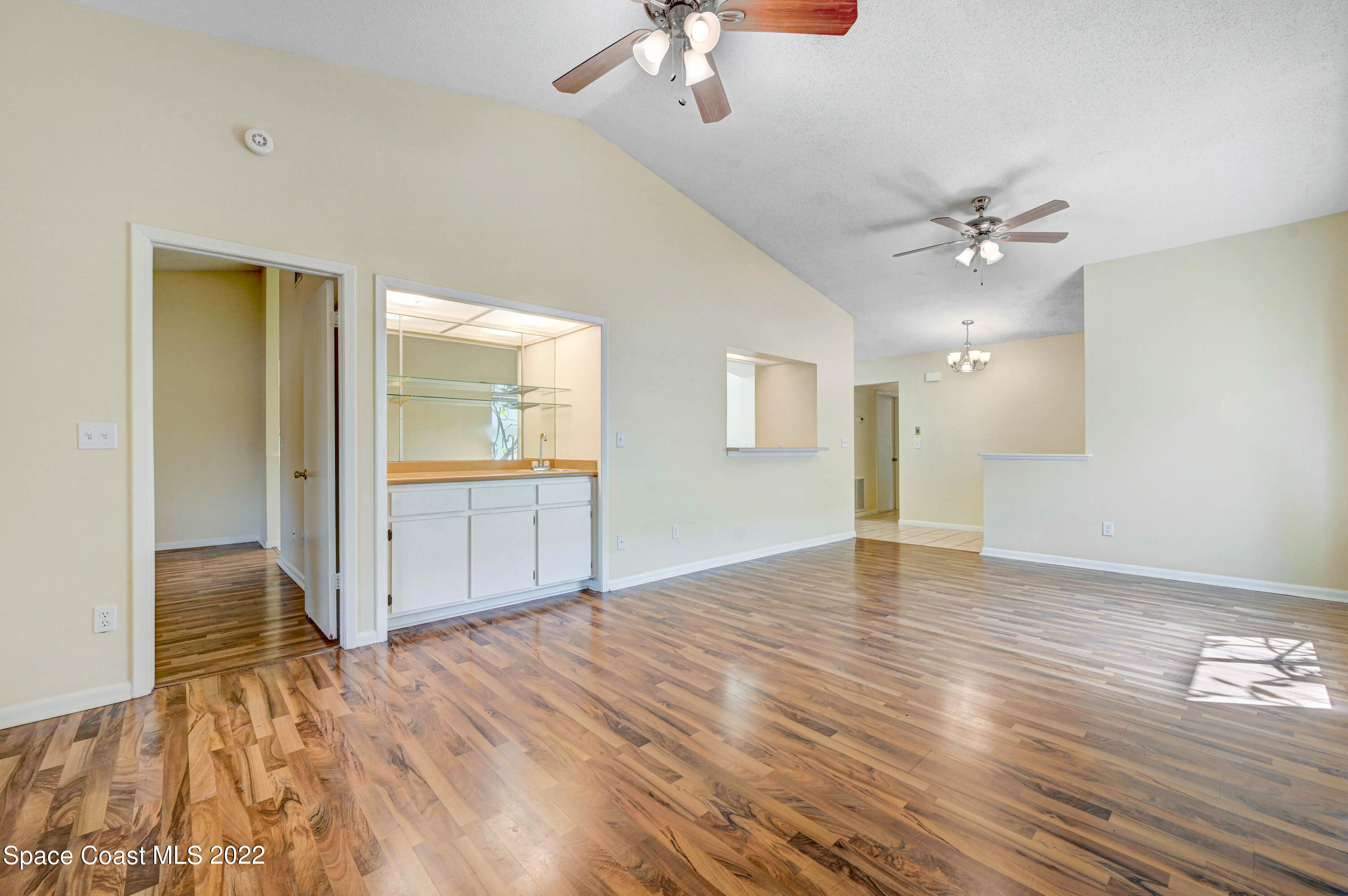373 Myrtlewood Road Melbourne, FL 32940 - Photo 21 of 42 wooden floor in an empty room with a window