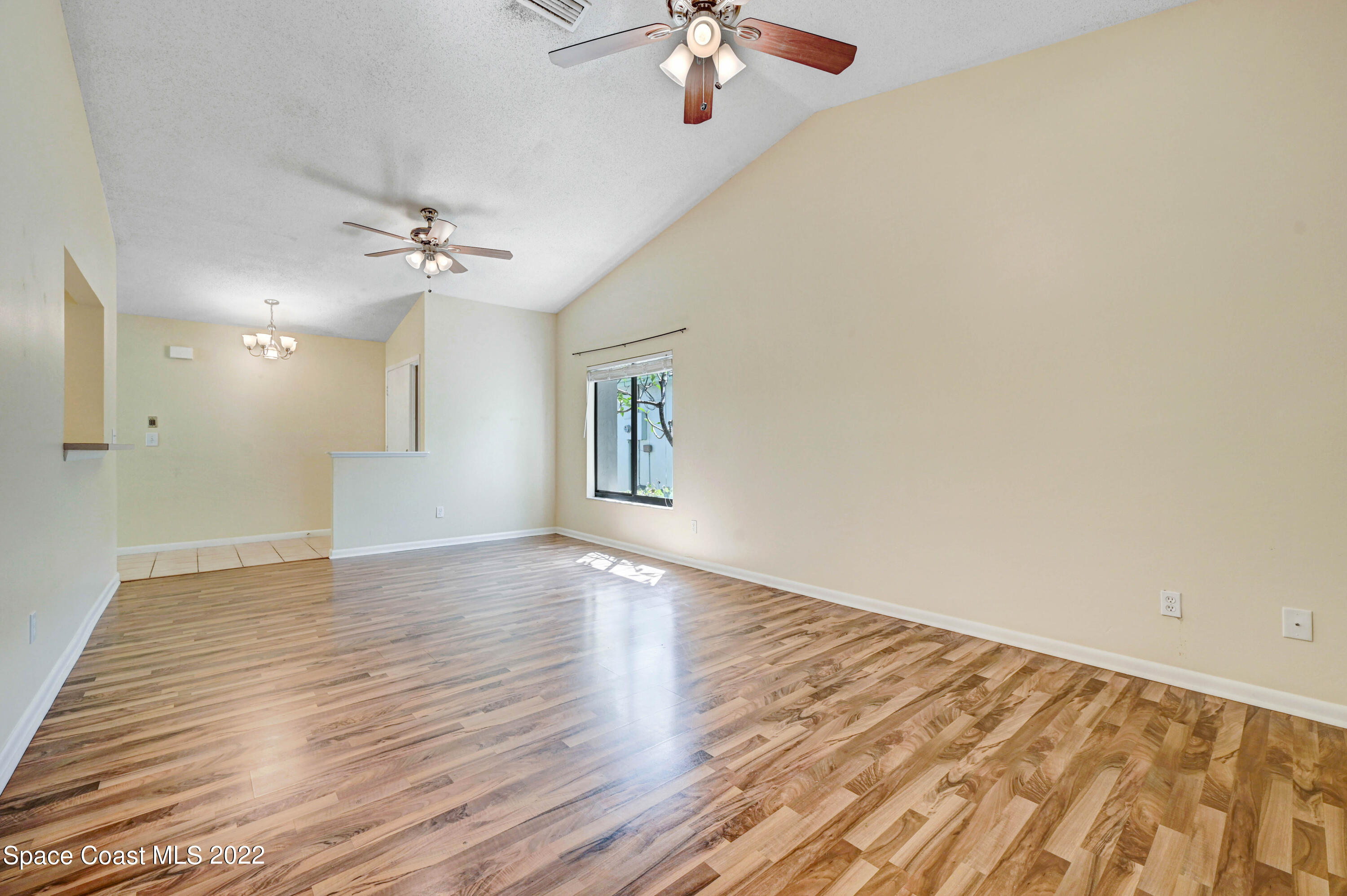 373 Myrtlewood Road Melbourne, FL 32940 - Photo 22 of 42 wooden floor in an empty room with a window