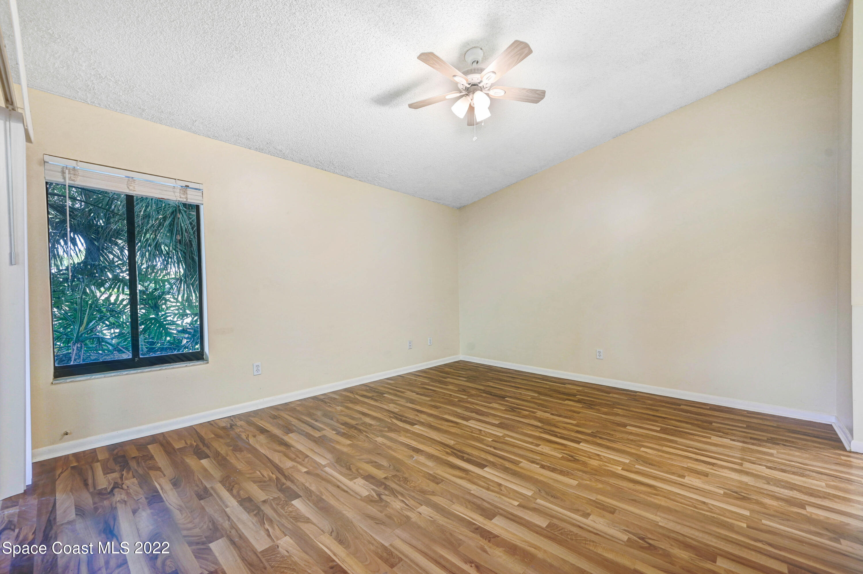 373 Myrtlewood Road Melbourne, FL 32940 - Photo 23 of 42 wooden floor in an empty room with a window