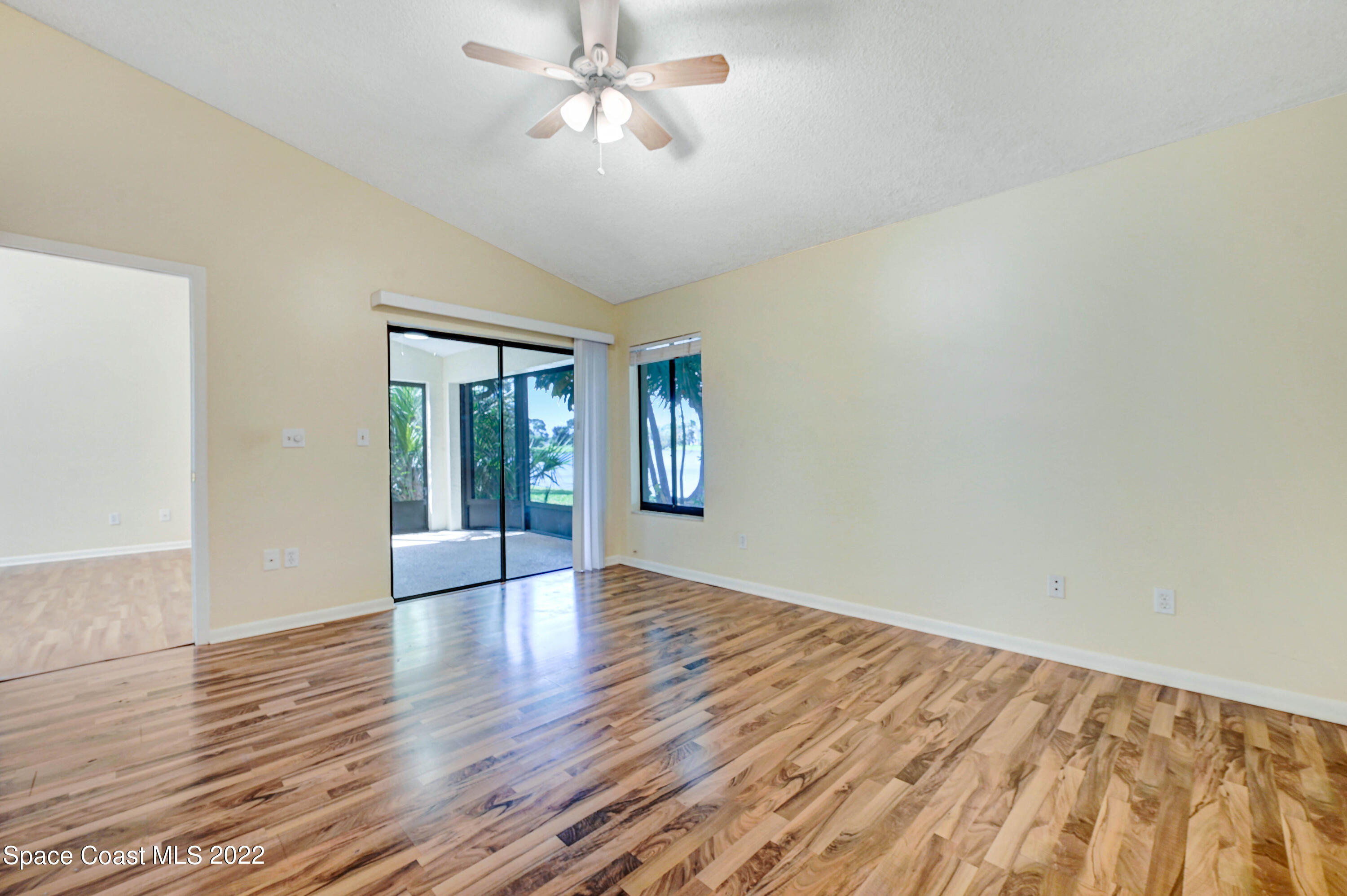 373 Myrtlewood Road Melbourne, FL 32940 - Photo 24 of 42 a view of an empty room with window and wooden floor