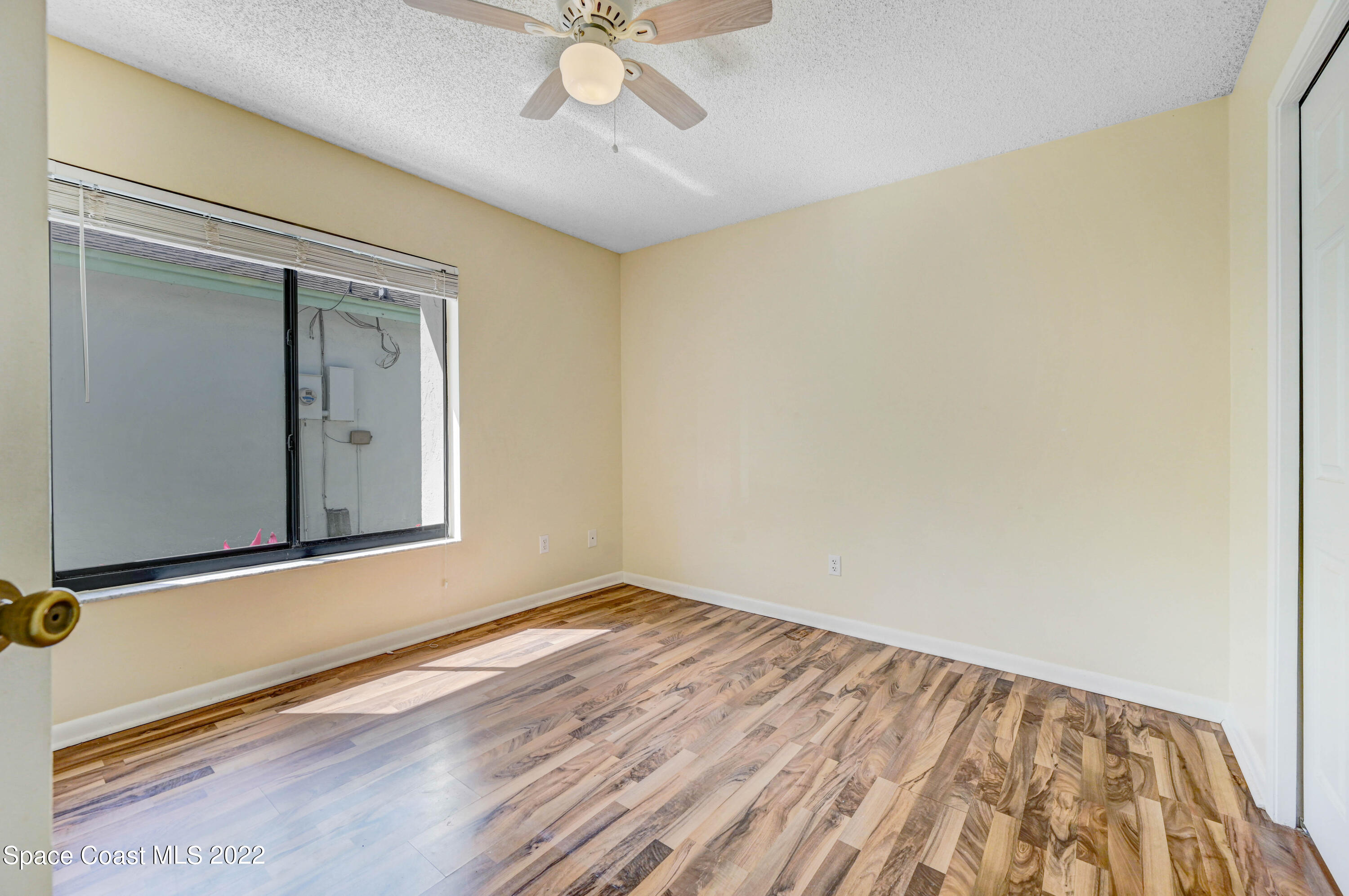 373 Myrtlewood Road Melbourne, FL 32940 - Photo 28 of 42 a view of a room with wooden floor and fan