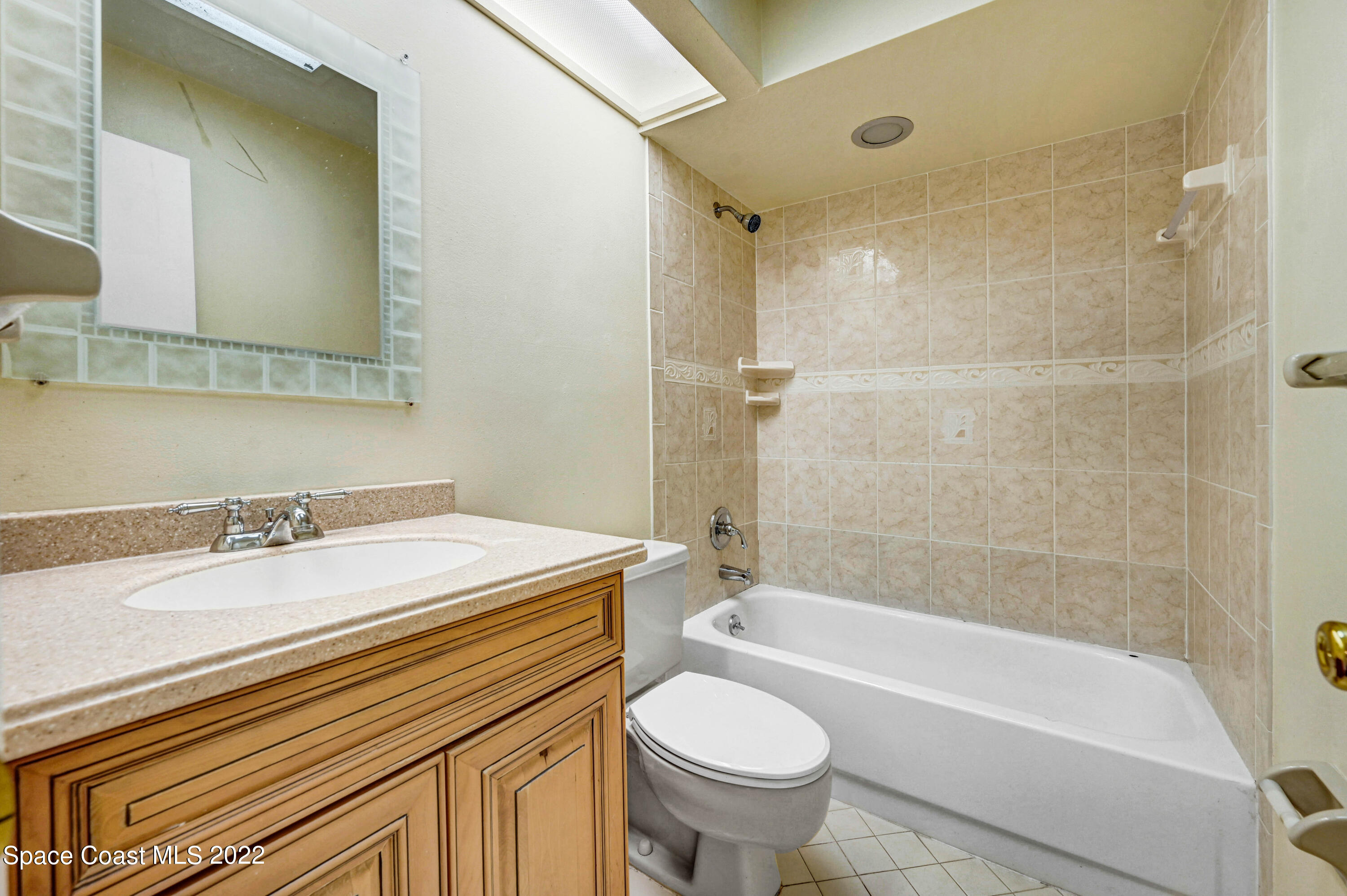 373 Myrtlewood Road Melbourne, FL 32940 - Photo 30 of 42 a bathroom with a sink and a mirror