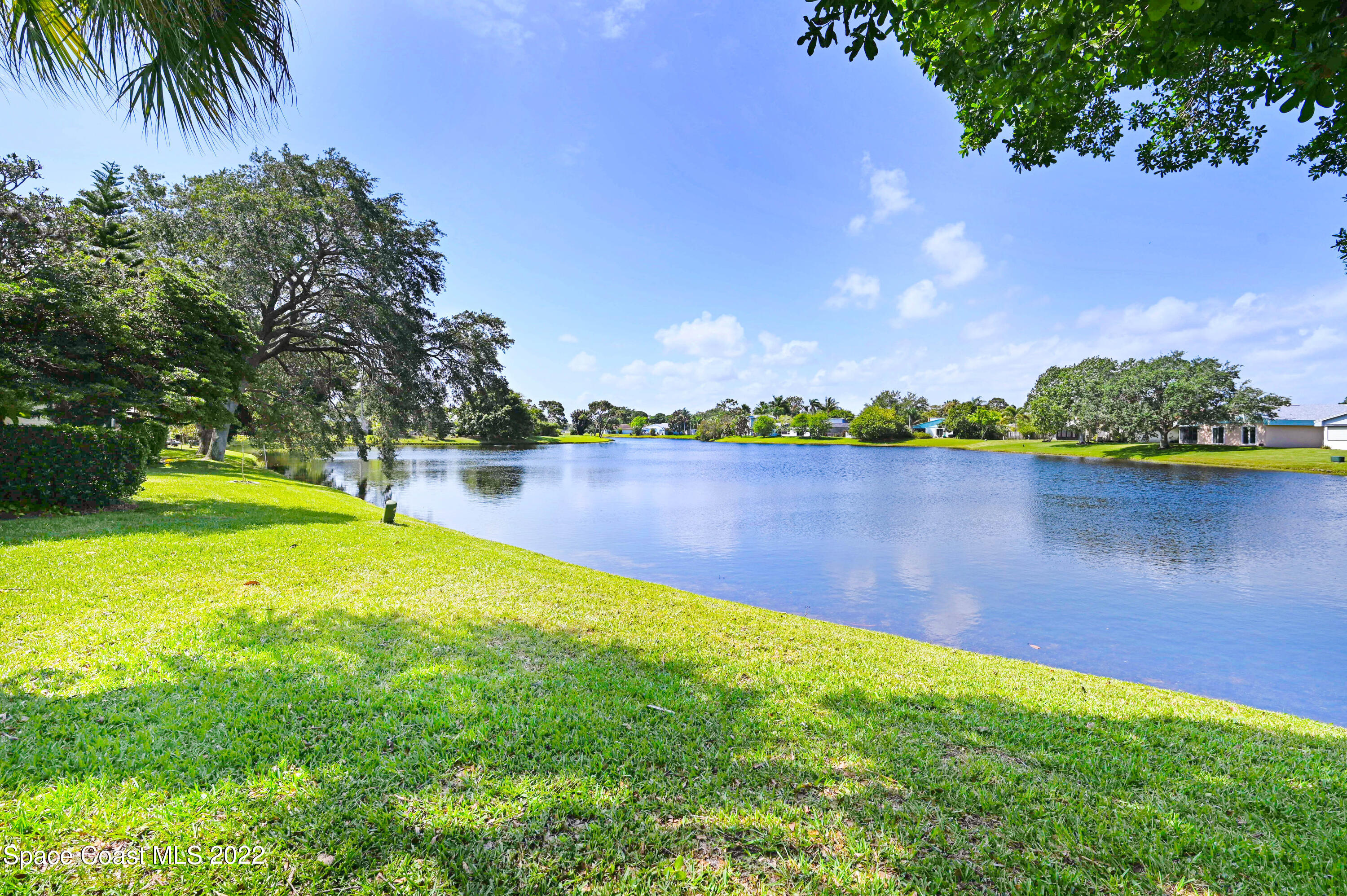 373 Myrtlewood Road Melbourne, FL 32940 - Photo 3 of 42 a view of a lake with houses in the back
