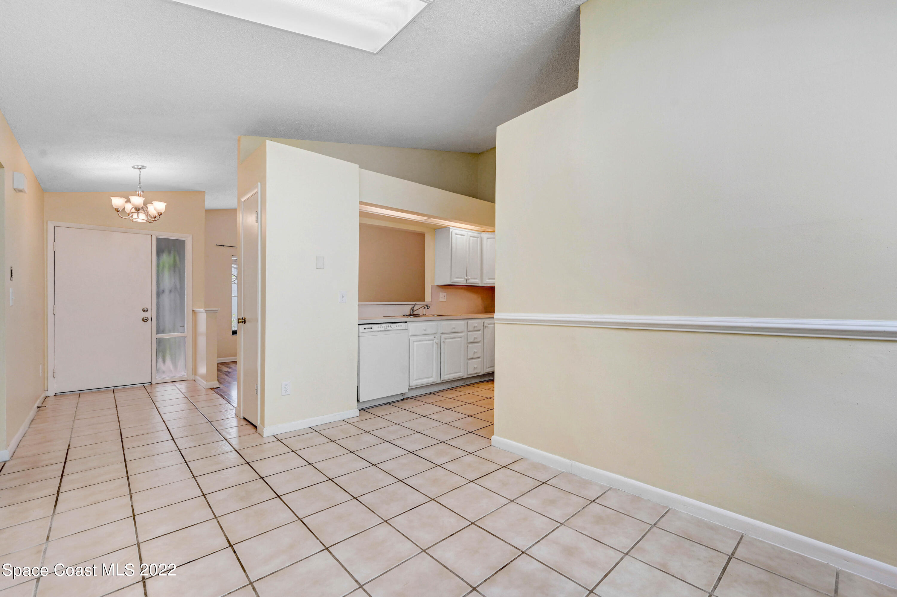 373 Myrtlewood Road Melbourne, FL 32940 - Photo 31 of 42 a view of a kitchen space with white cabinets
