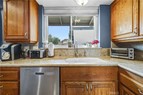 a kitchen with granite countertop a sink and a window