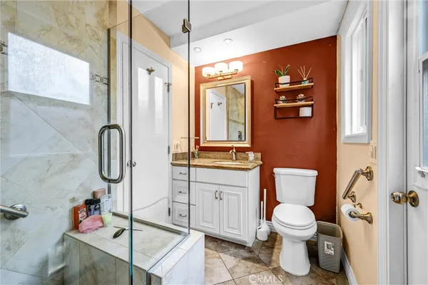 a bathroom with a toilet sink shower and mirror