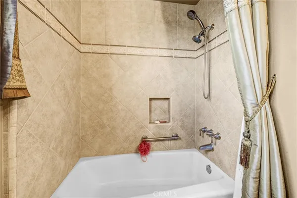 a bathroom with a granite countertop sink a toilet and shower