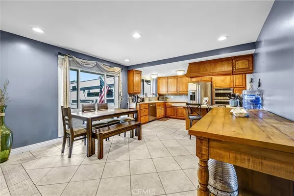 a living room with furniture pool table and large windows