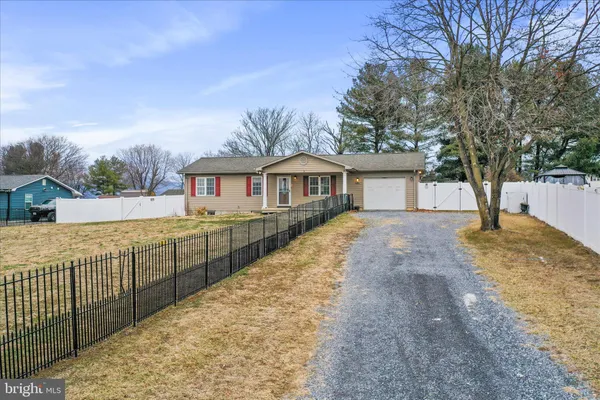 a view of house with outdoor space and trees around