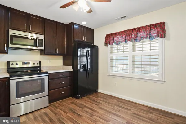 a kitchen with stainless steel appliances granite countertop a refrigerator stove and microwave