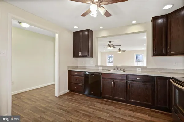 a spacious bathroom with a granite countertop sink a mirror and a bathtub