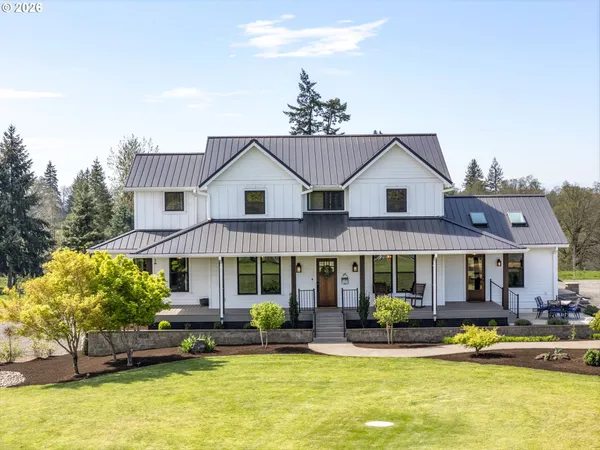 a view of a house with swimming pool and furniture