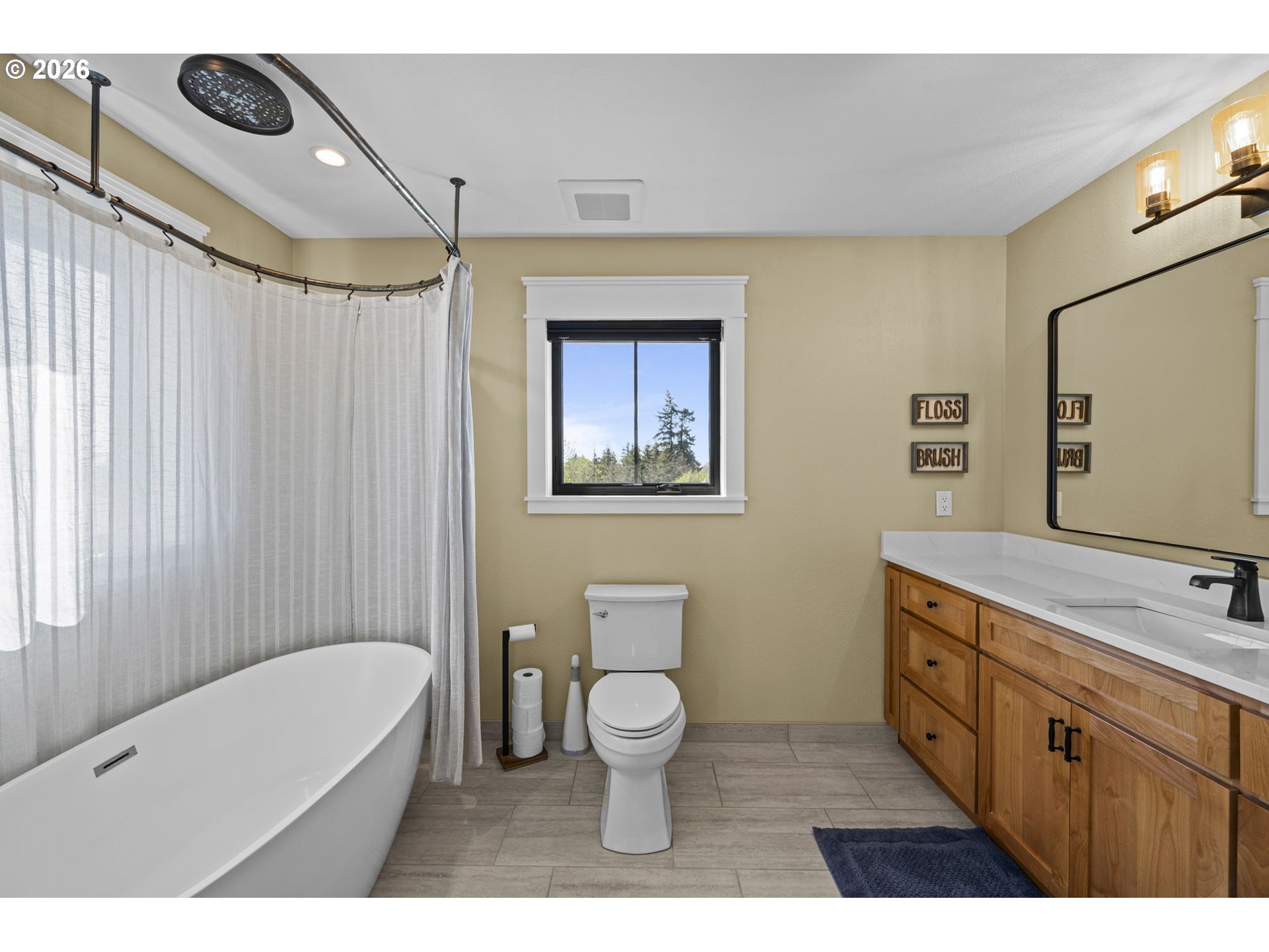 33246 South Wilhoit Road Molalla, OR 97038 - Photo 20 of 48 a bathroom with a toilet a sink a tub and mirror