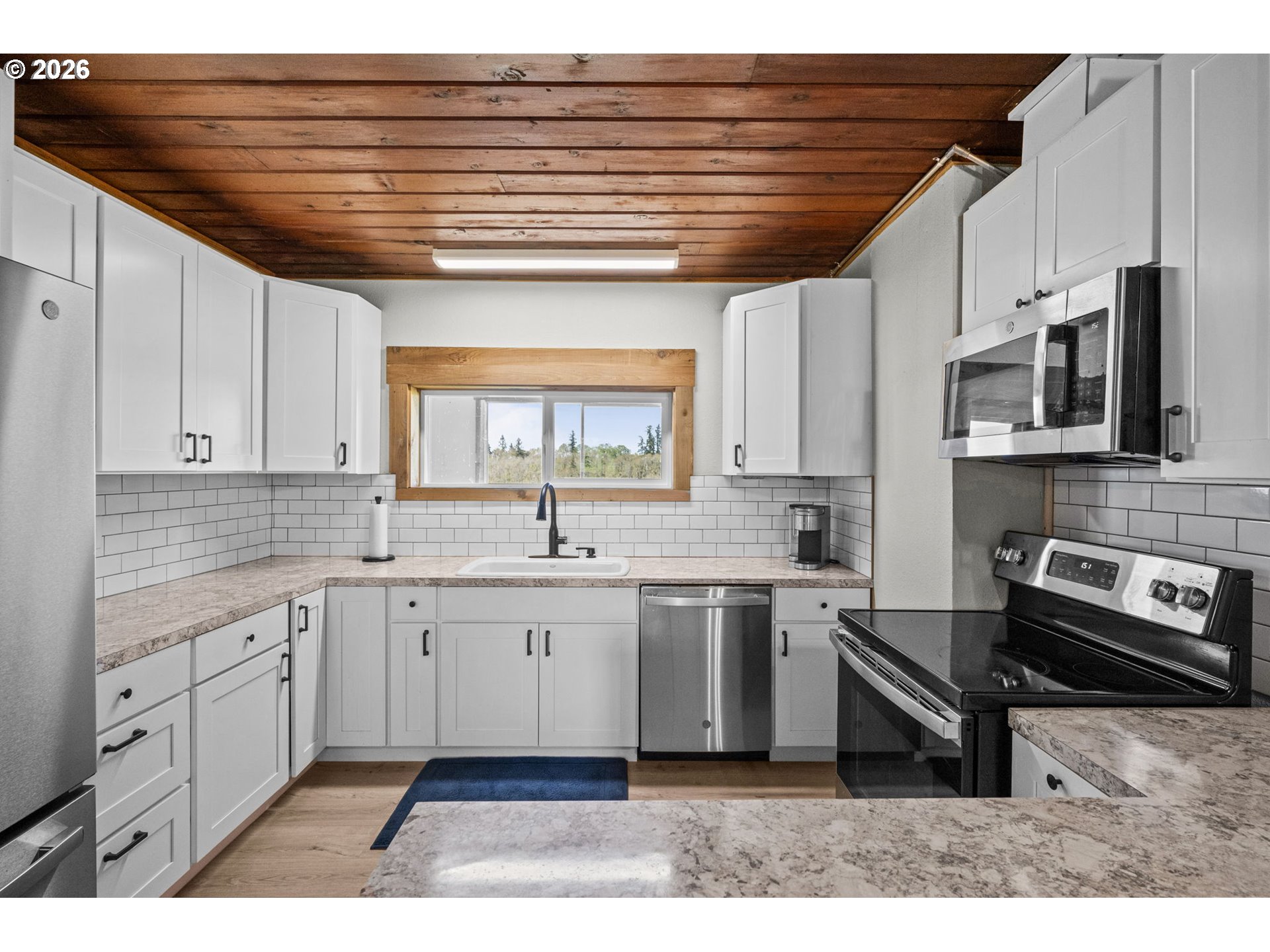 33246 South Wilhoit Road Molalla, OR 97038 - Photo 43 of 48 a kitchen with stainless steel appliances granite countertop a sink a stove a microwave and cabinets