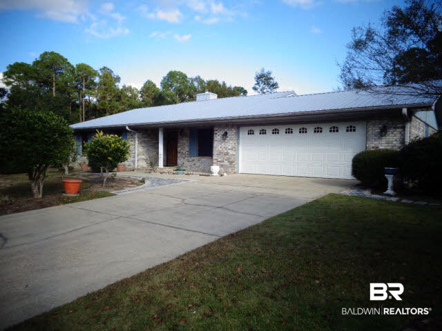 2804 Pine Ridge Drive Lillian, AL 36549 - Photo 2 of 39 140x190 lot. Brick exterior. Vinyl soffit/fascia/gutters. Metal roof,2012. Metal working storm shutters around the home. Solar screens for front windows, 2014.