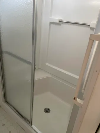 a bathroom with a glass shower door