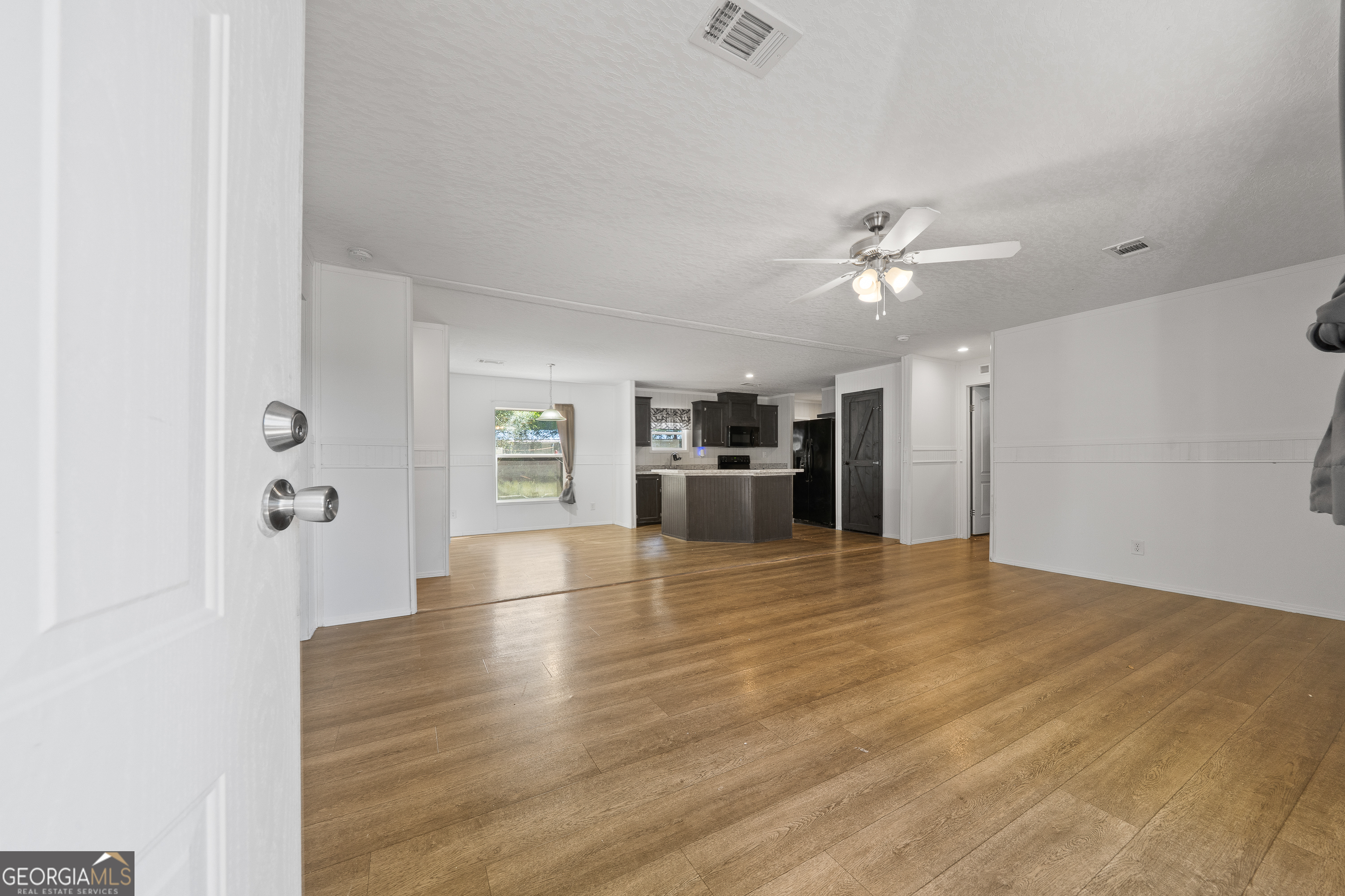 280 Lakeview Drive Locust Grove, GA 30248 - Photo 4 of 43 wooden floor in an empty room with a kitchen