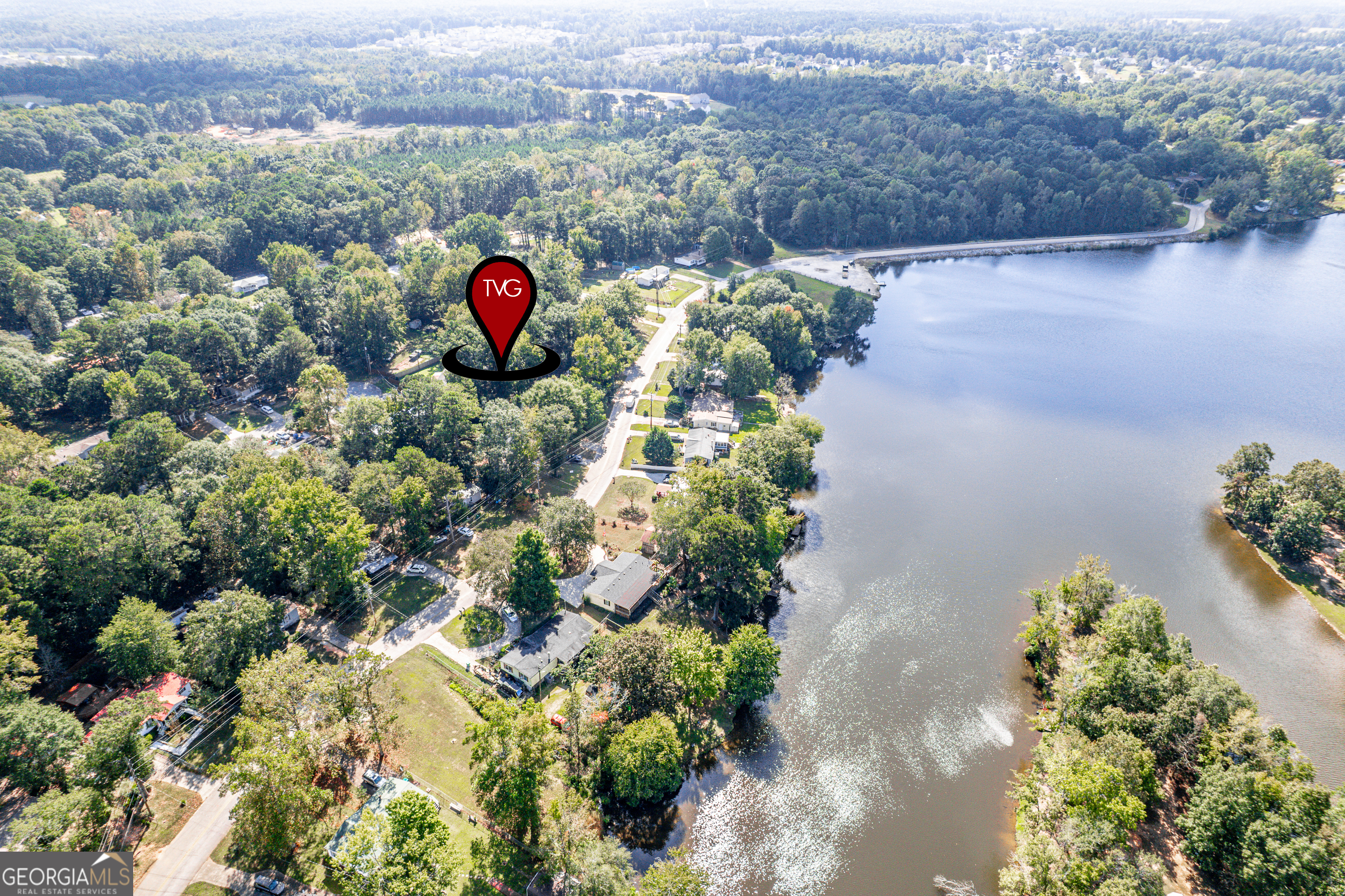280 Lakeview Drive Locust Grove, GA 30248 - Photo 42 of 43 an aerial view of a house with a yard and a lake view
