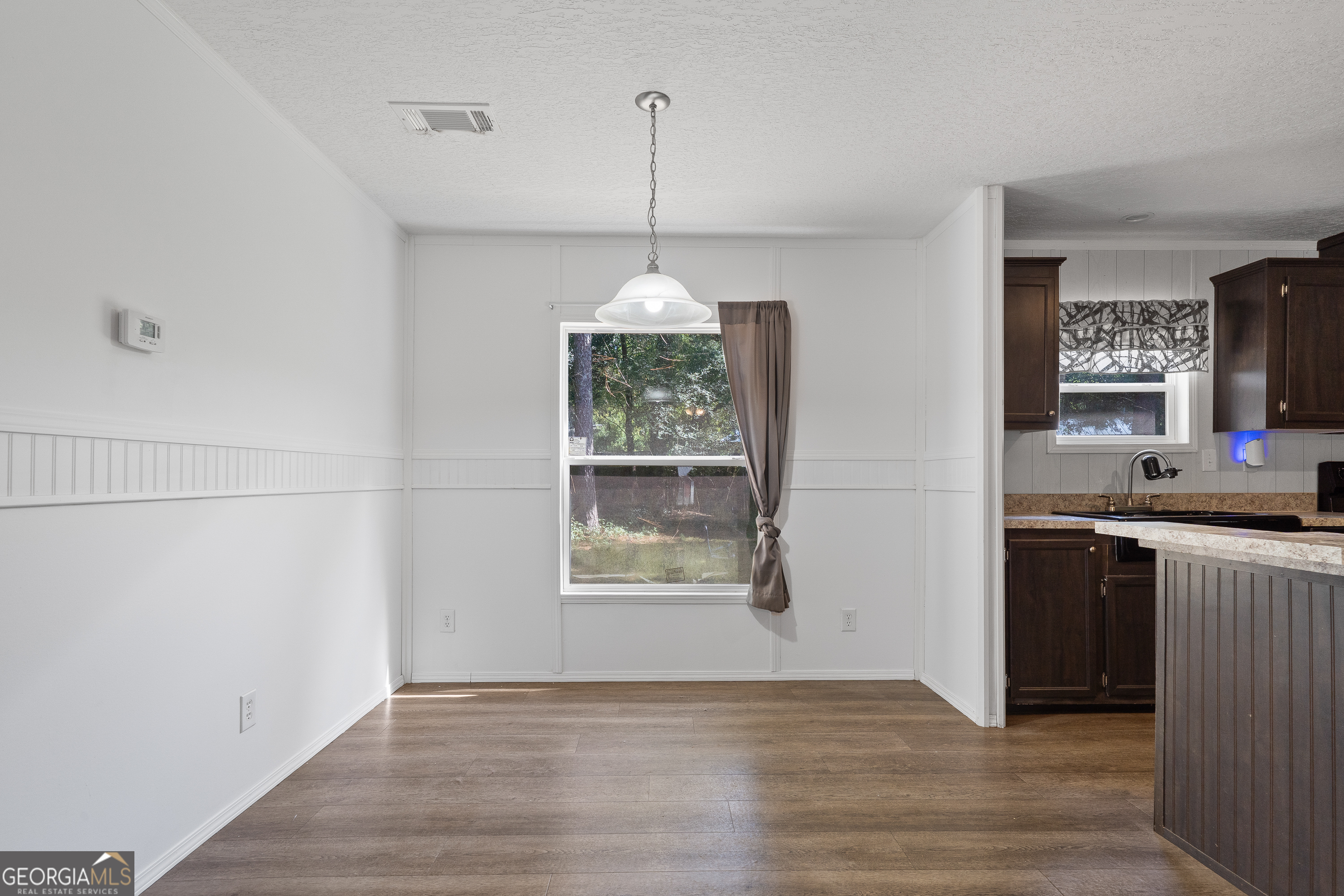 280 Lakeview Drive Locust Grove, GA 30248 - Photo 9 of 43 a kitchen with kitchen island granite countertop a stove a refrigerator and a wooden floor