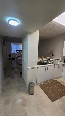 a kitchen with a sink a stove and cabinets
