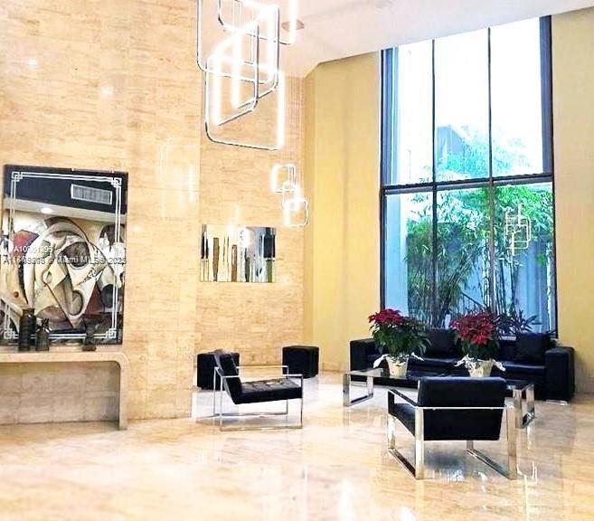 2750 Northeast 183rd Street, Unit 1404 Aventura, FL 33160 - Photo 11 of 14 a living room with furniture and a large window