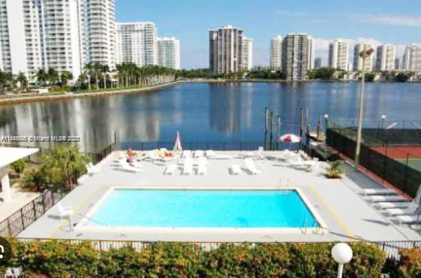 2750 Northeast 183rd Street, Unit 1404 Aventura, FL 33160 - Photo 12 of 14 a view of swimming pool with a yard and lake view