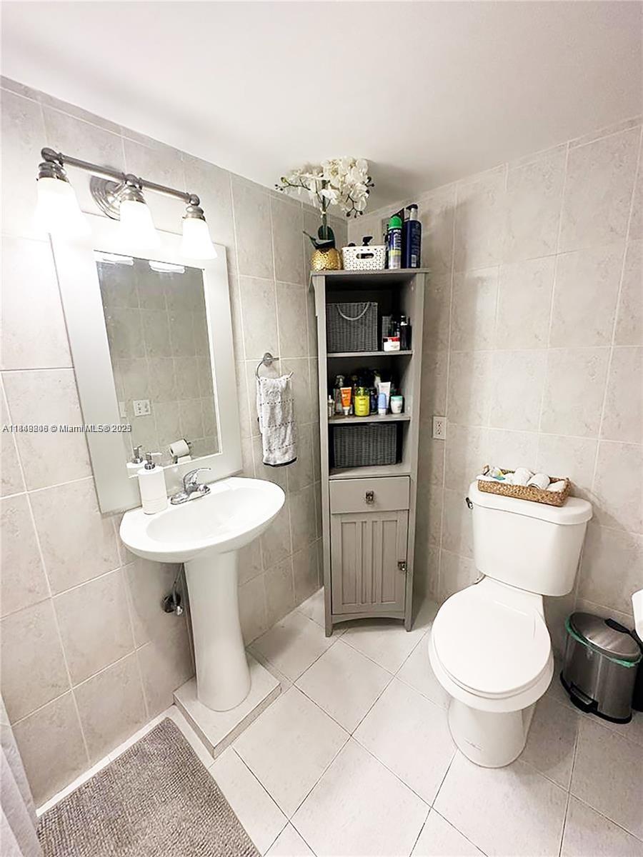 2750 Northeast 183rd Street, Unit 1404 Aventura, FL 33160 - Photo 9 of 14 a bathroom with a sink toilet and shower