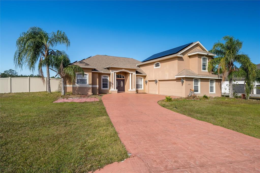 8131 Spring Forest Lane Wesley Chapel, FL 33544 - Photo 1 of 1 a front view of a house with a yard and palm tree
