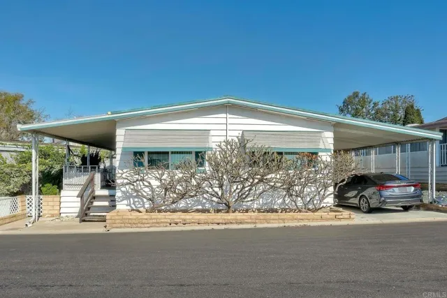 a car parked in front of white building