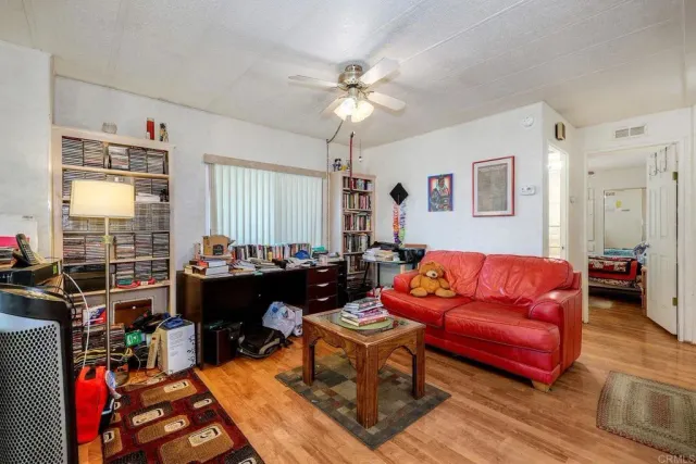 a view of a workspace with furniture and a window
