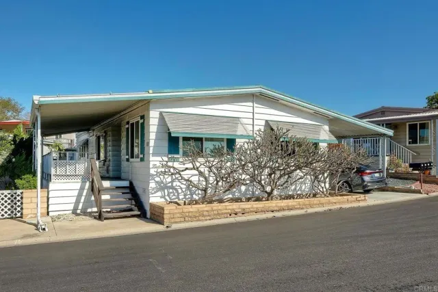 a backyard of a house with fountain table and chairs