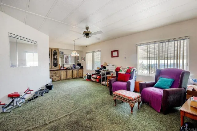 a view of a livingroom with furniture and a flat screen tv