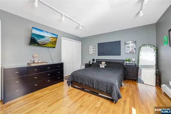 a living room with a bed and flat screen tv