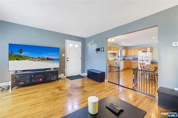 a living room with furniture flat screen tv and a table