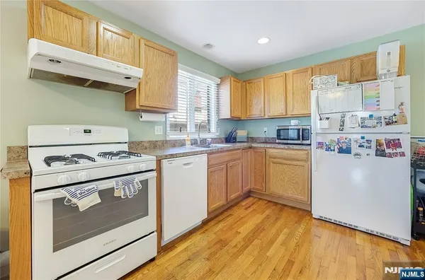 a kitchen with a stove a sink and a refrigerator