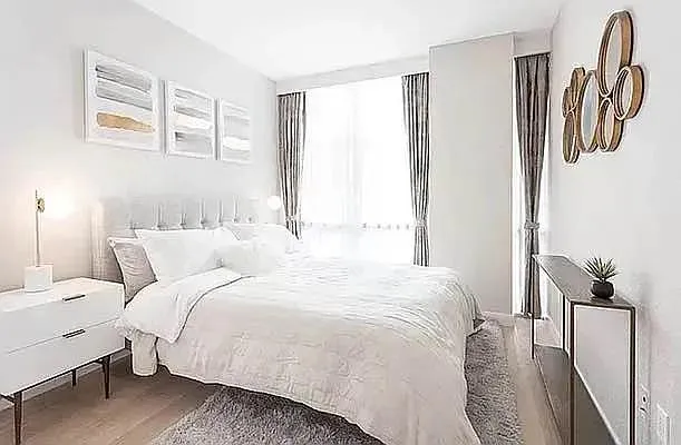 a living room with furniture and floor to ceiling windows