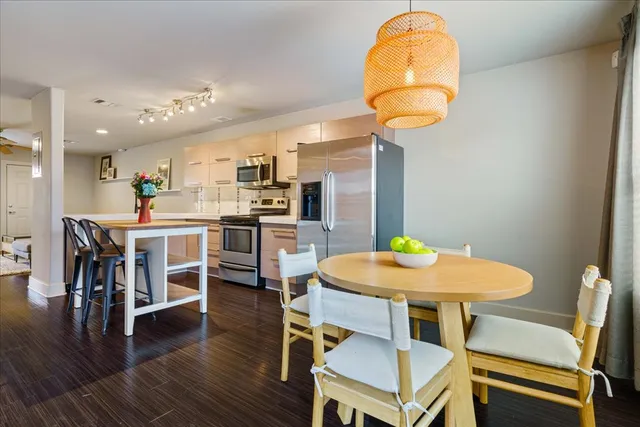 a dining room with furniture and wooden floor