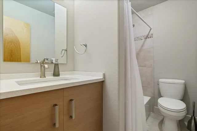 a bathroom with a toilet and shower