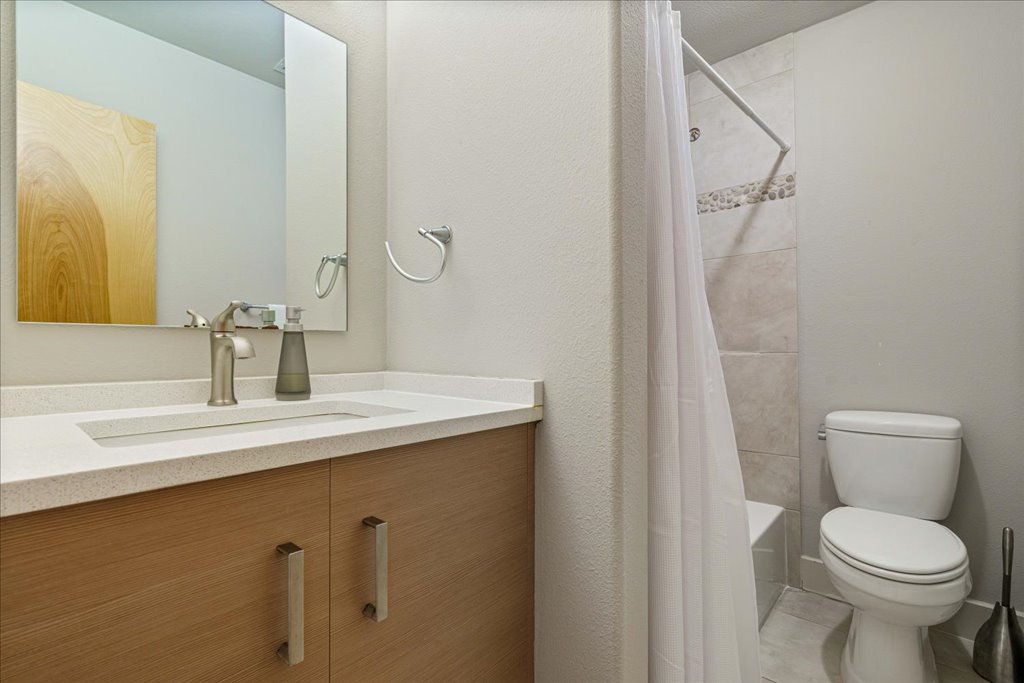 1101 Grove Boulevard, Unit 203 Austin, TX 78741 - Photo 21 of 27 a bathroom with a sink toilet and shower