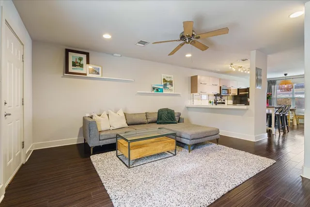 a living room with furniture and wooden floor