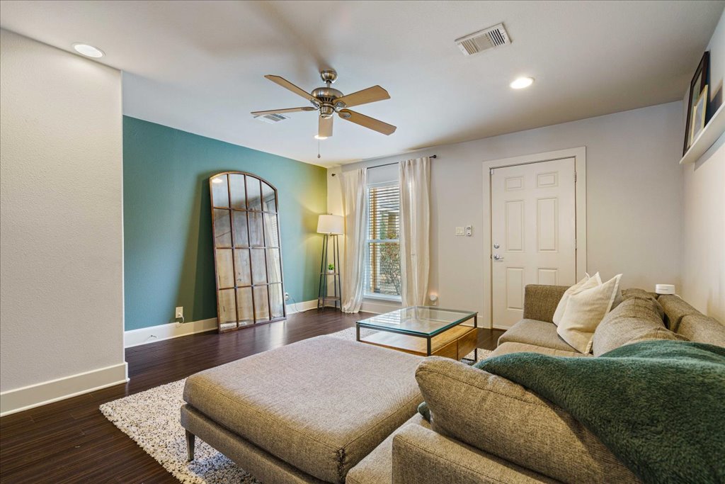 1101 Grove Boulevard, Unit 203 Austin, TX 78741 - Photo 7 of 27 a living room with a bed and wooden floor