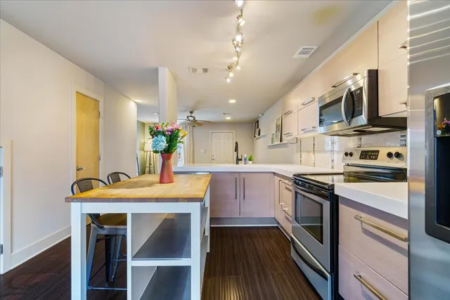 a kitchen with stainless steel appliances granite countertop a stove refrigerator sink and cabinets