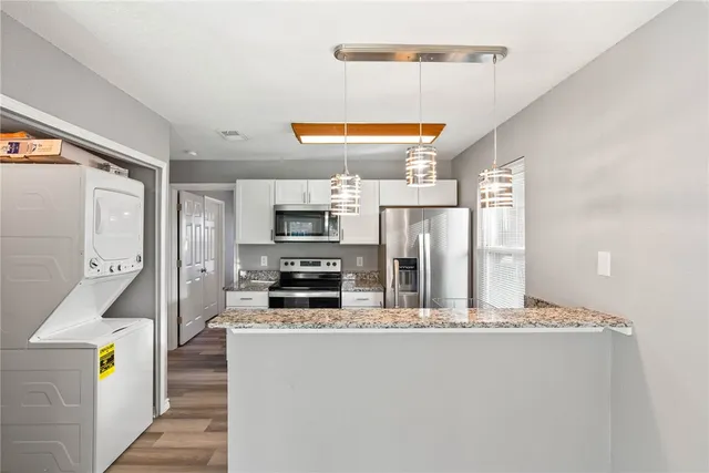 a kitchen with stainless steel appliances a refrigerator and a stove