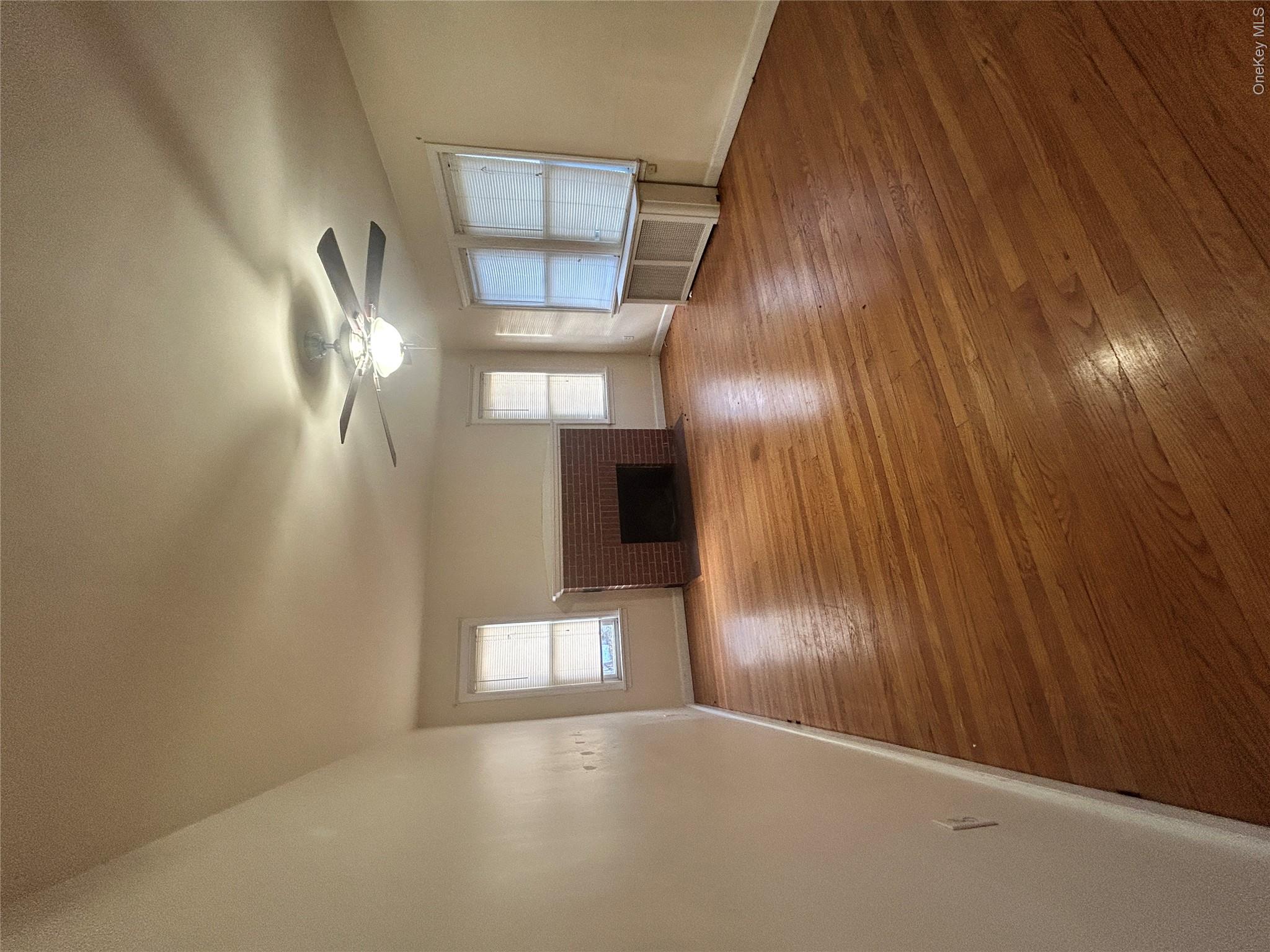 853 Little Britain Road New Windsor, NY 12553 - Photo 17 of 22 wooden floor in an empty room with a window