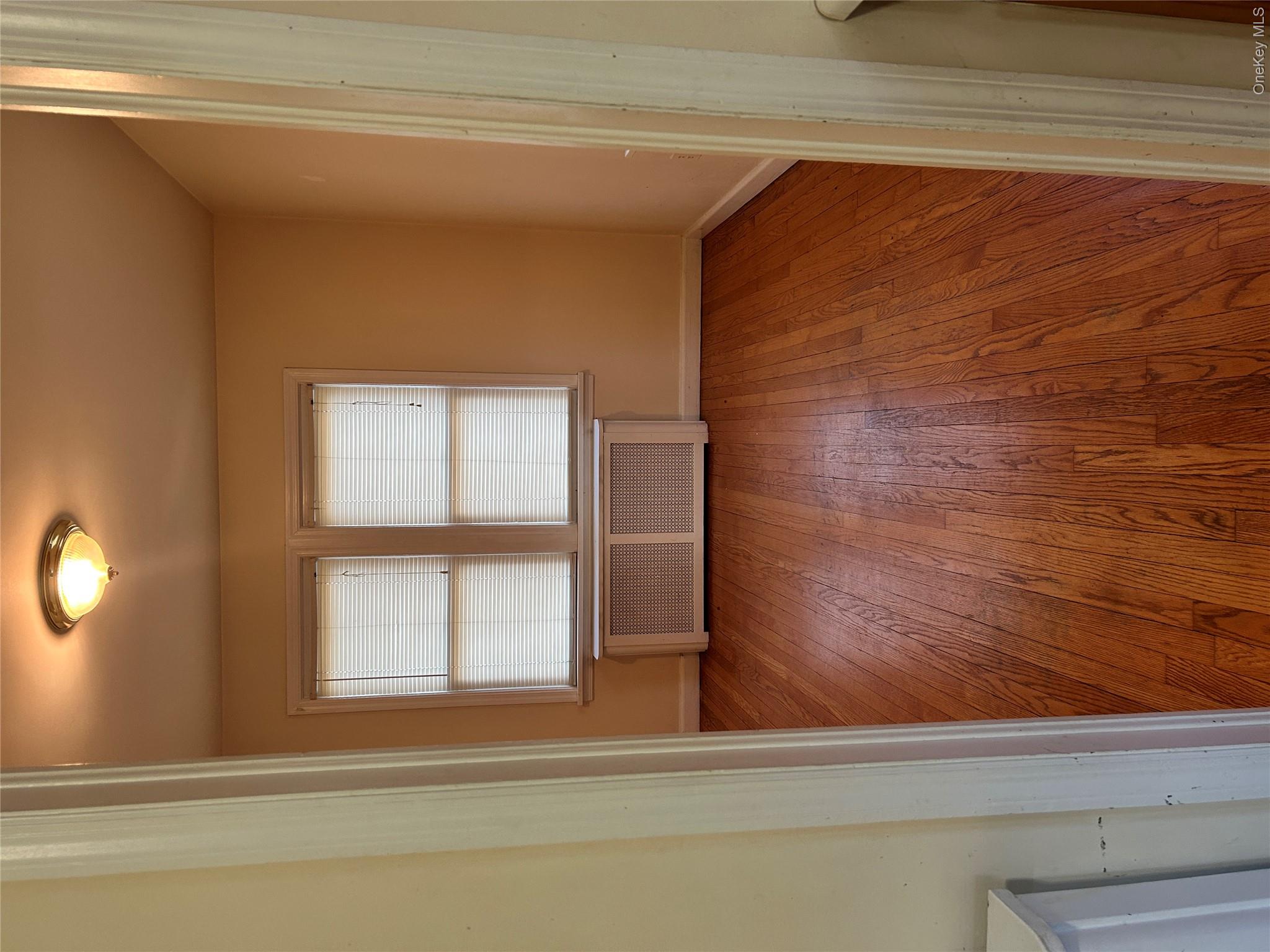 853 Little Britain Road New Windsor, NY 12553 - Photo 2 of 22 an empty room with wooden floor and windows