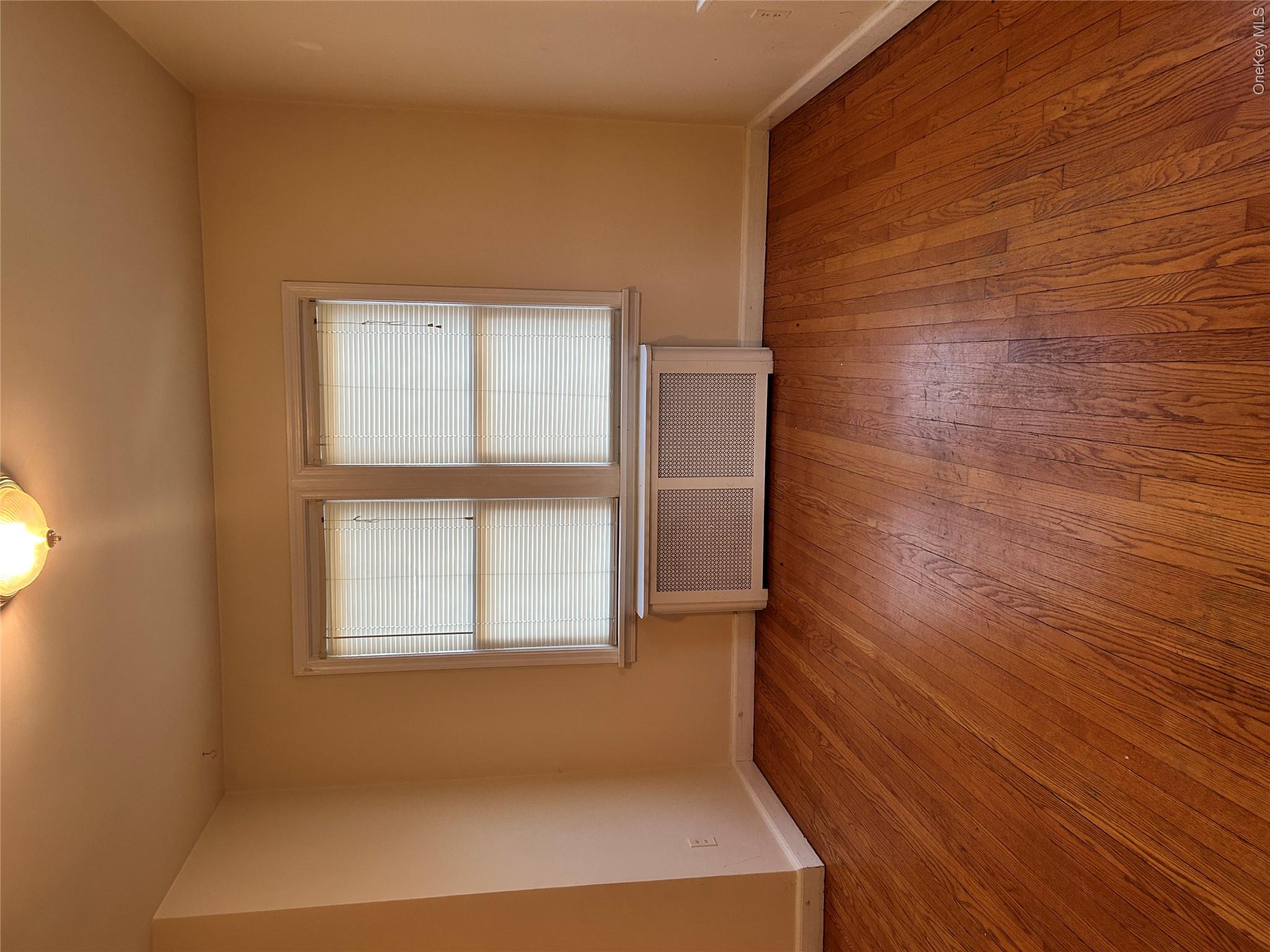 853 Little Britain Road New Windsor, NY 12553 - Photo 3 of 22 an empty room with wooden floor and windows
